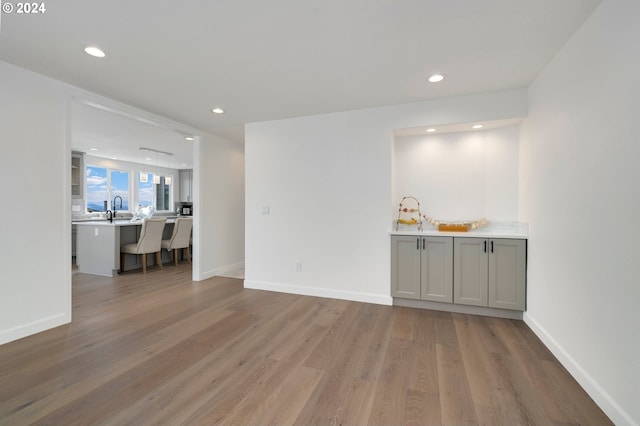 interior space featuring recessed lighting, wood finished floors, and baseboards