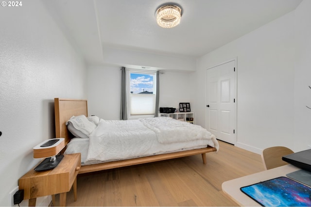 bedroom with baseboards and light wood-style floors