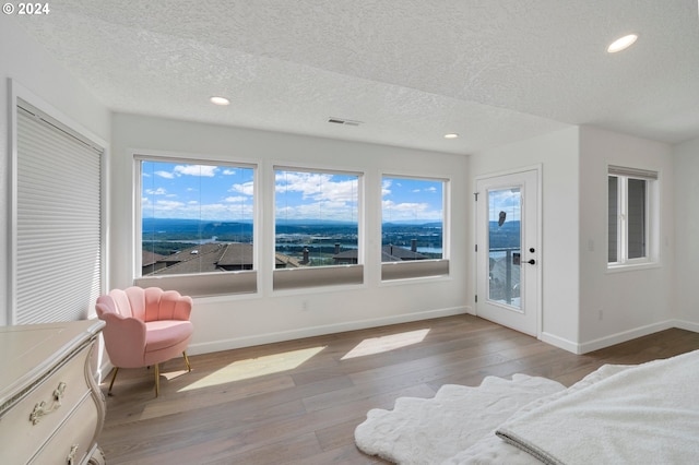 bedroom with access to exterior, recessed lighting, baseboards, and hardwood / wood-style floors