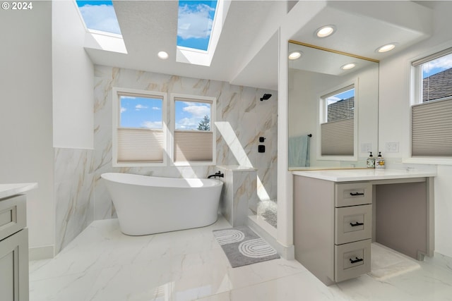 full bath featuring marble finish floor, recessed lighting, a marble finish shower, a freestanding bath, and vanity