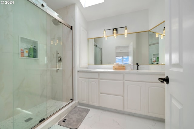 bathroom featuring marble finish floor, a sink, a marble finish shower, a skylight, and double vanity