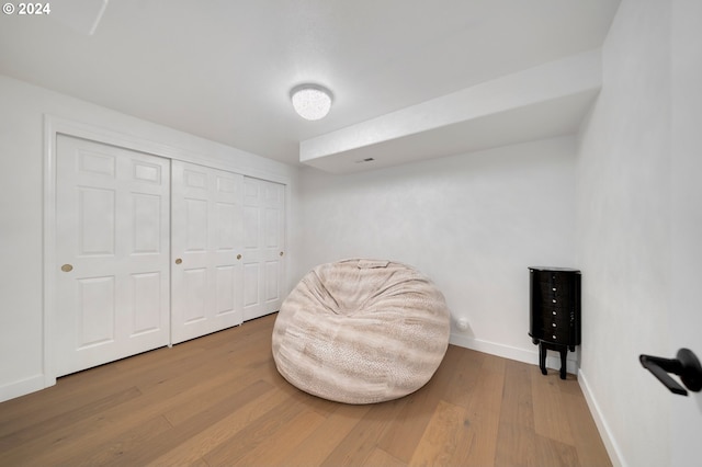 living area featuring wood finished floors and baseboards