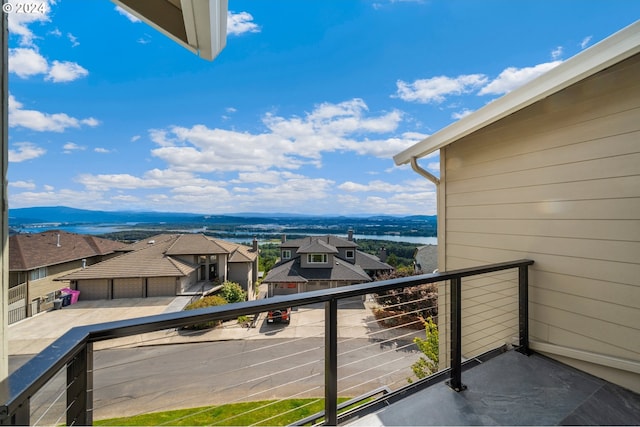 balcony featuring a residential view and a mountain view