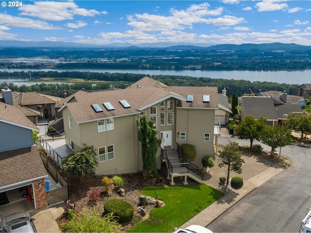 birds eye view of property with a residential view and a water and mountain view