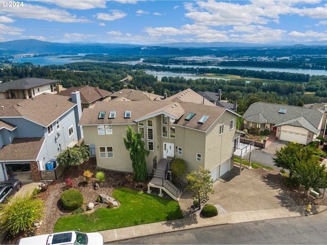 drone / aerial view featuring a residential view and a water view