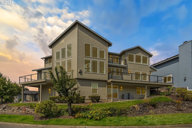 back of house with a balcony and central AC unit