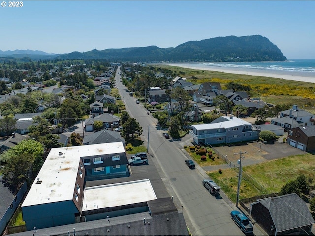 drone / aerial view featuring a water and mountain view