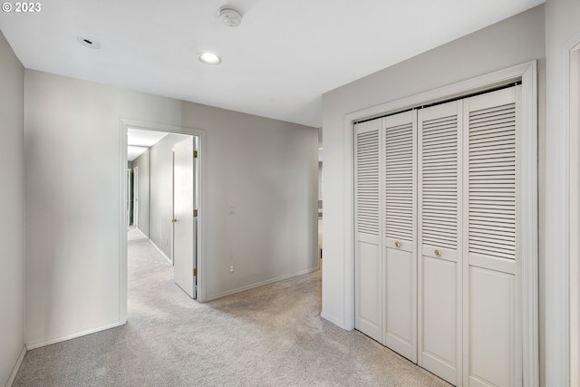 hall with light carpet, recessed lighting, and baseboards