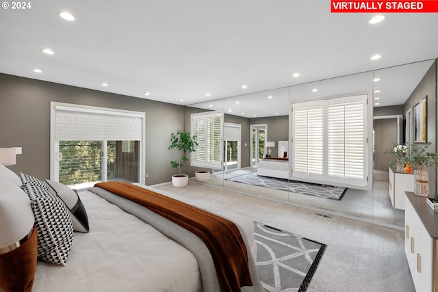 carpeted bedroom featuring recessed lighting, multiple windows, and access to exterior