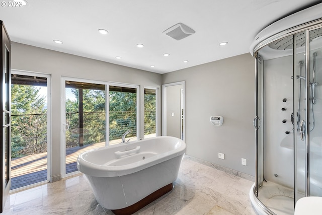 bathroom featuring independent shower and bath and plenty of natural light