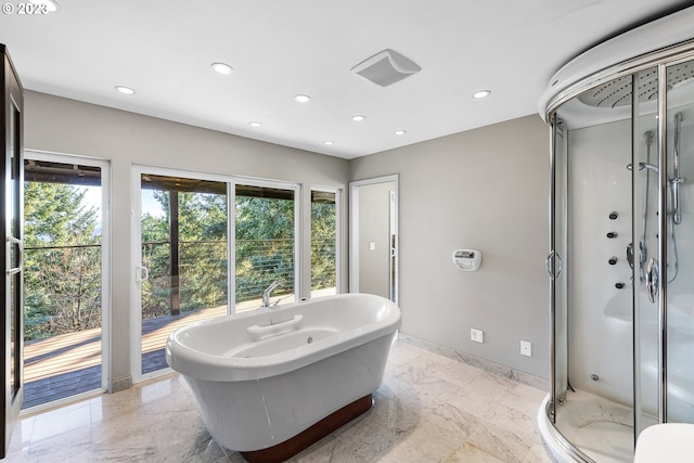 bathroom featuring recessed lighting, marble finish floor, and a stall shower