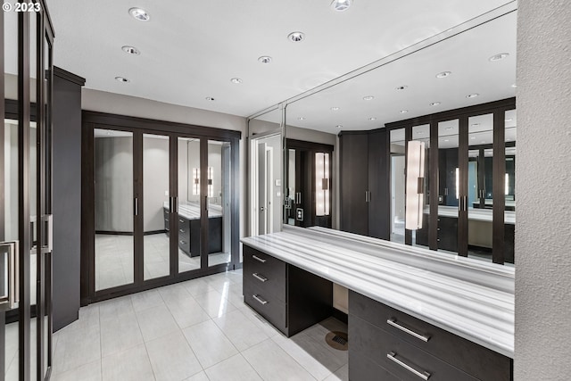 bathroom with tile patterned floors, recessed lighting, french doors, and elevator