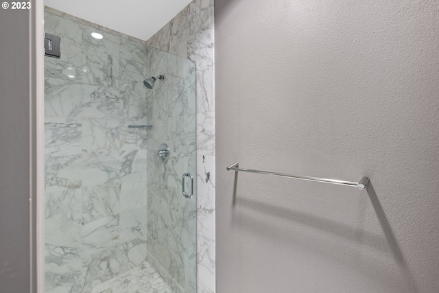 bathroom with a shower with shower door