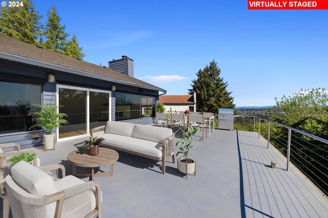 view of patio featuring area for grilling, a balcony, outdoor dining area, and an outdoor hangout area
