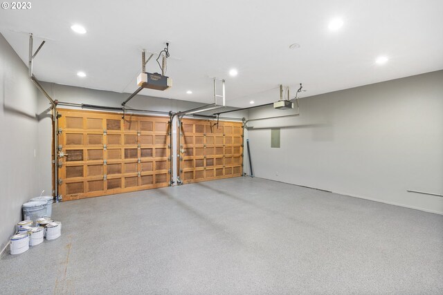 garage with recessed lighting and a garage door opener