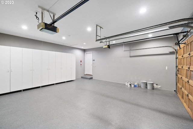 garage featuring recessed lighting and a garage door opener