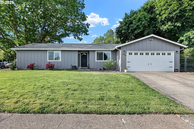 single story home with board and batten siding, an attached garage, and driveway