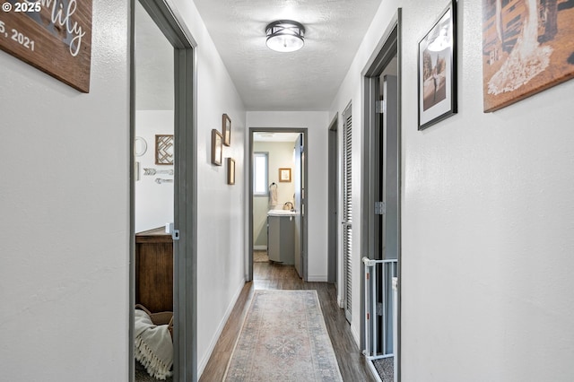 hallway featuring wood finished floors and baseboards