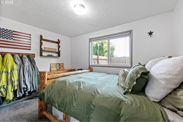 carpeted bedroom featuring a textured ceiling