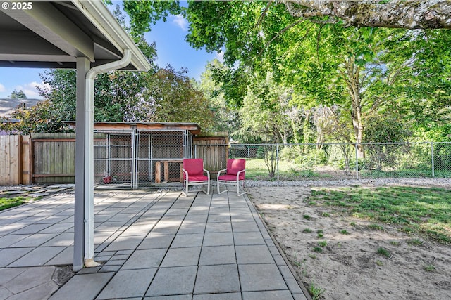 view of patio featuring a fenced backyard and an outbuilding
