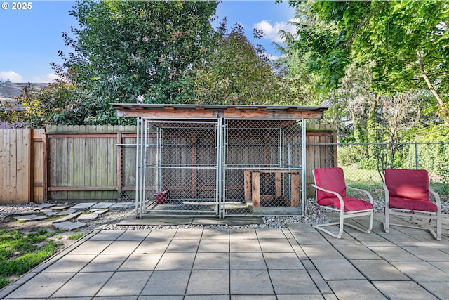 view of outdoor structure featuring an exterior structure, an outbuilding, and fence