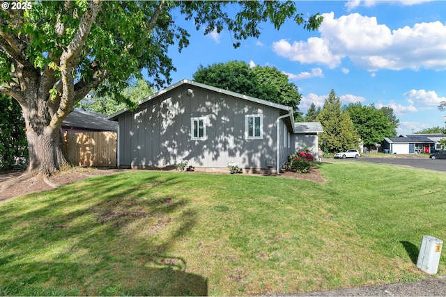 view of side of property with a lawn