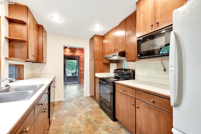 kitchen featuring a textured ceiling, sink, light tile floors, and black appliances