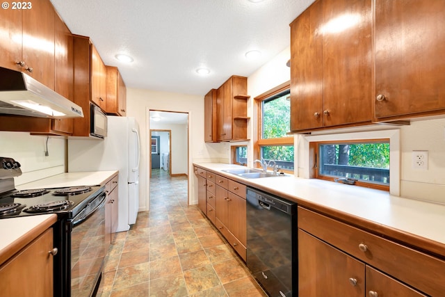 kitchen featuring light tile flooring, sink, and black appliances