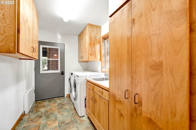 washroom with independent washer and dryer, cabinets, and light tile floors