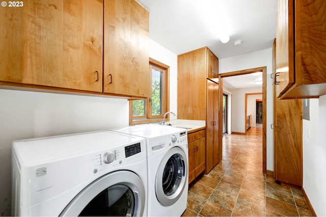 laundry room featuring sink, cabinets, washer and dryer, and dark tile floors