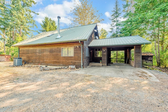 view of front of house featuring central air condition unit and a carport