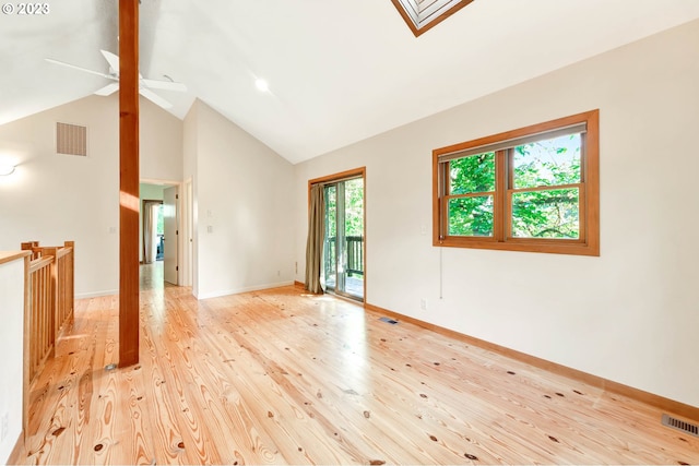 spare room with high vaulted ceiling, light hardwood / wood-style floors, and ceiling fan