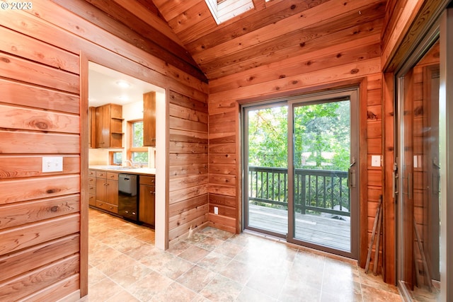 interior space with wooden ceiling, wood walls, tile flooring, vaulted ceiling with skylight, and vanity