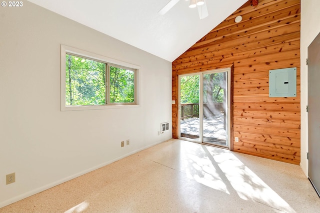 unfurnished room with wood walls, lofted ceiling, ceiling fan, and plenty of natural light