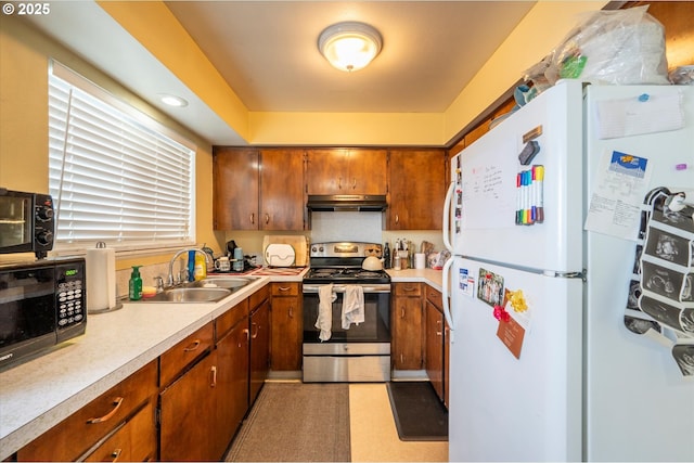 kitchen featuring white refrigerator, sink, and electric range