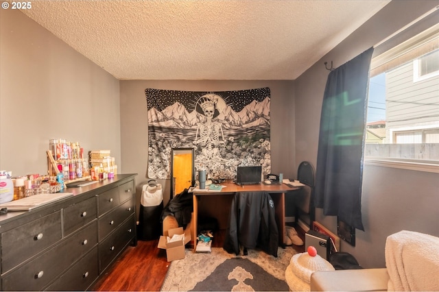 home office with dark hardwood / wood-style flooring and a textured ceiling