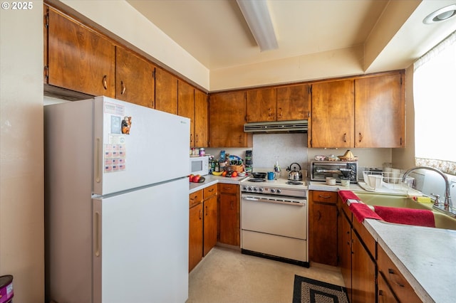 kitchen with sink and white appliances