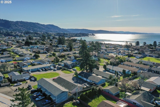 drone / aerial view with a water and mountain view