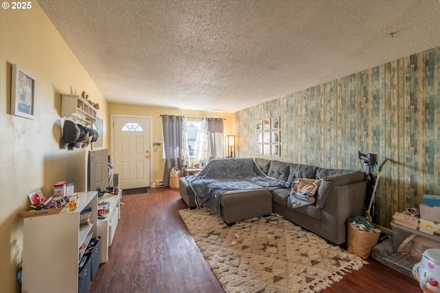 living room with dark hardwood / wood-style floors and a textured ceiling