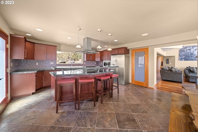 kitchen featuring a kitchen island, stainless steel appliances, island exhaust hood, pendant lighting, and backsplash