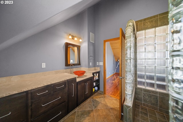 bathroom with vanity, vaulted ceiling, and hardwood / wood-style flooring