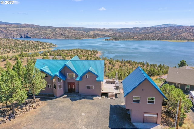 birds eye view of property featuring a water and mountain view