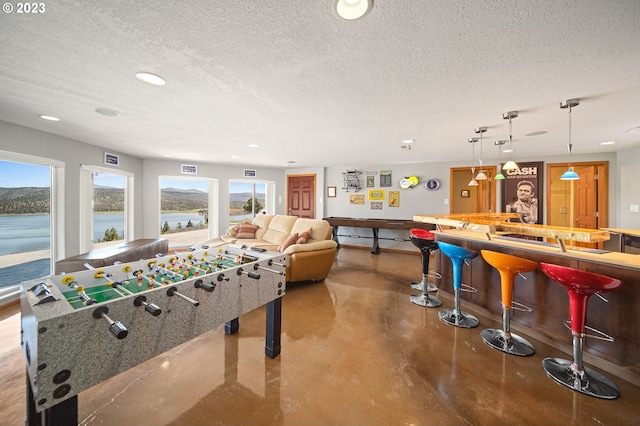 playroom featuring a textured ceiling