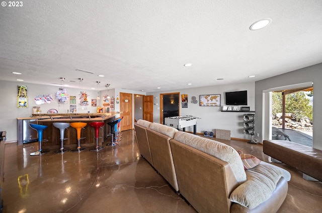 living room with a textured ceiling and indoor bar