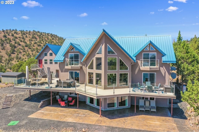 rear view of house featuring a patio area and a mountain view