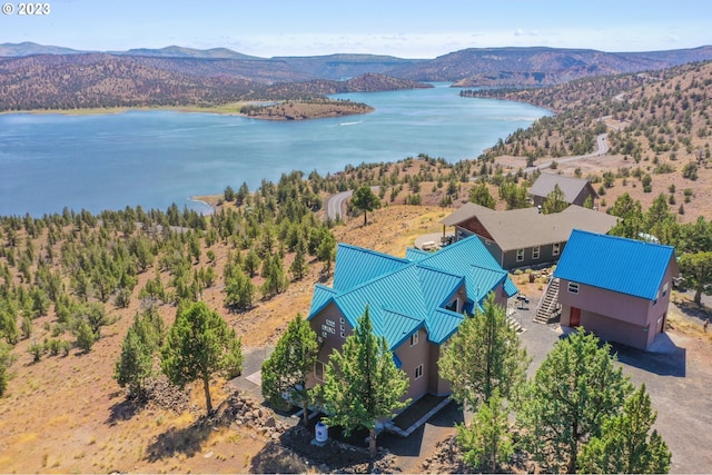 drone / aerial view featuring a water and mountain view