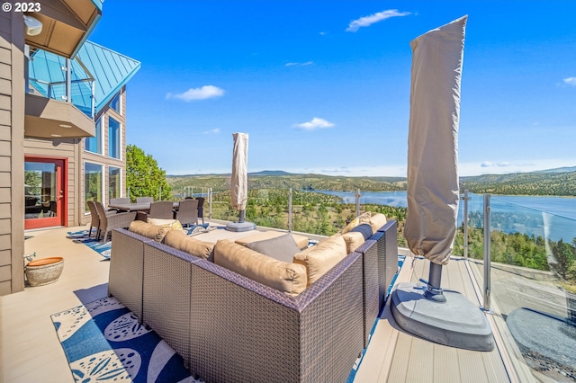 deck with an outdoor hangout area and a water view