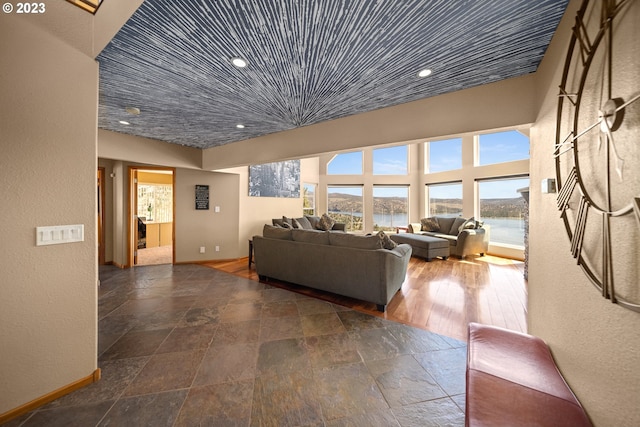 tiled living room featuring a water view