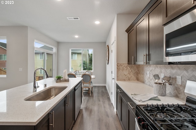 1647 N Millican Creek St, Lafayette, OR 97127 - kitchen with stainless steel appliances, dark brown cabinetry, wood finished floors, backsplash, and recessed lighting