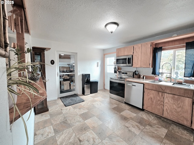 2951 NE Yount Ave, Roseburg, OR 97470 - kitchen featuring appliances with stainless steel finishes, a sink, a textured ceiling, light countertops, and light brown cabinets